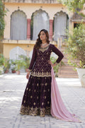 Woman wearing a wine colored faux blooming sharara set with sequins embroidery and a dupatta.
