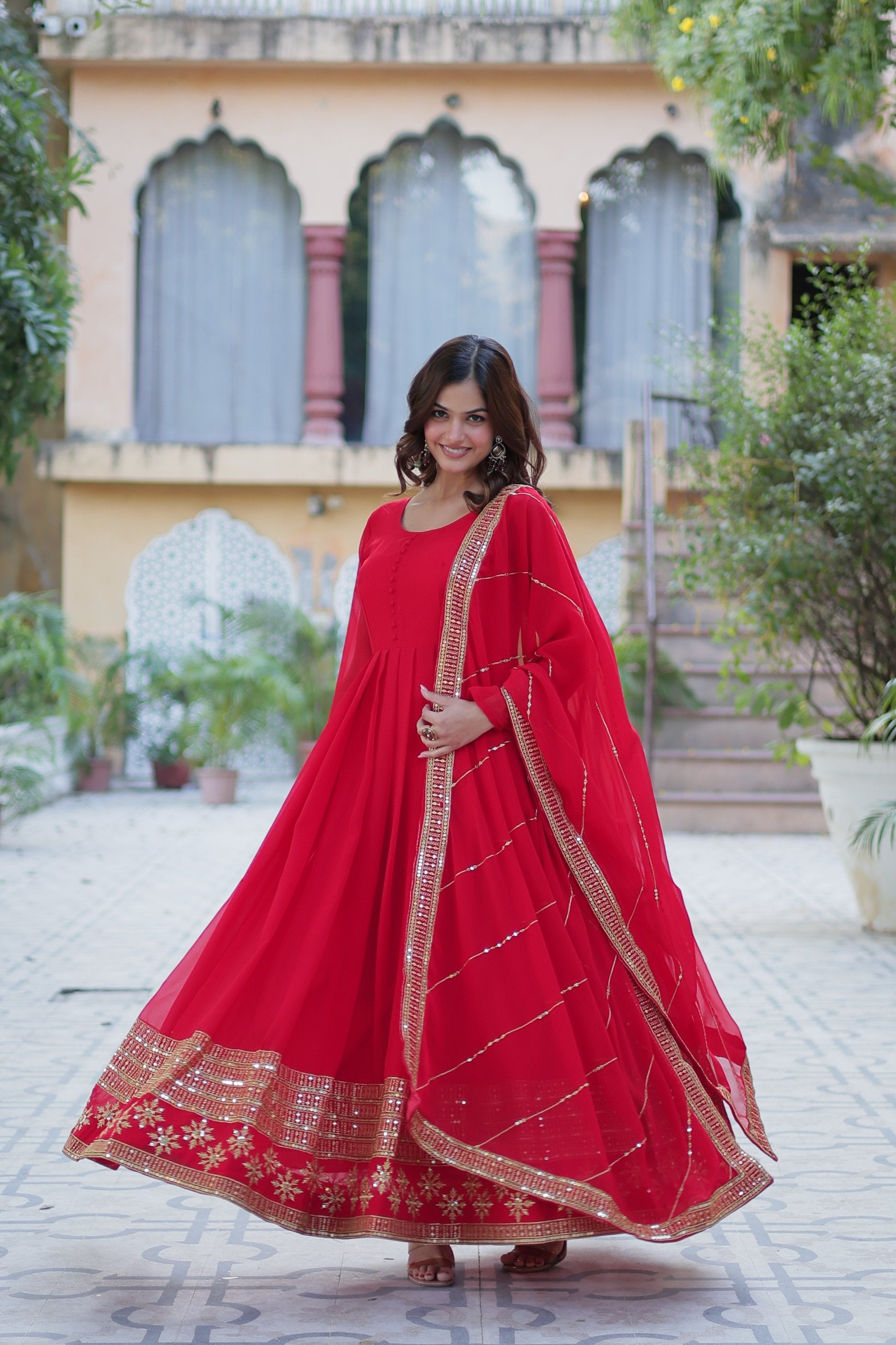 Woman wearing a Red Faux Blooming Anarkali set with multi-sequin embroidery and matching dupatta