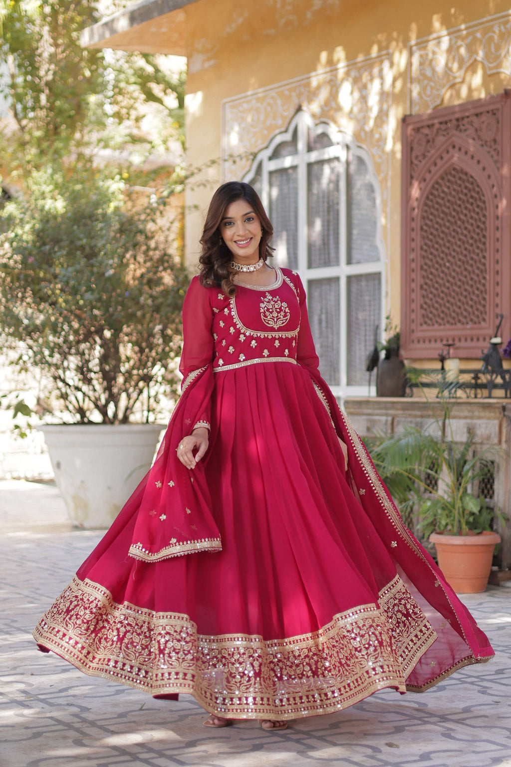 Elegant Pink Faux Georgette Anarkali with intricate sequins embroidery.