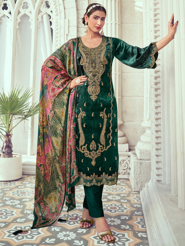 Woman wearing a luxurious green velvet straight kurta with digital print, pashmina trousers, and a pure silk dupatta.