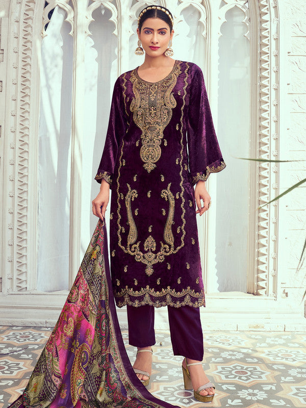 A woman wearing a purple velvet straight kurta with digital print, matching trousers, and a dupatta.