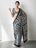 Woman wearing a black Chinon ready-to-wear saree with digital prints and a lace border