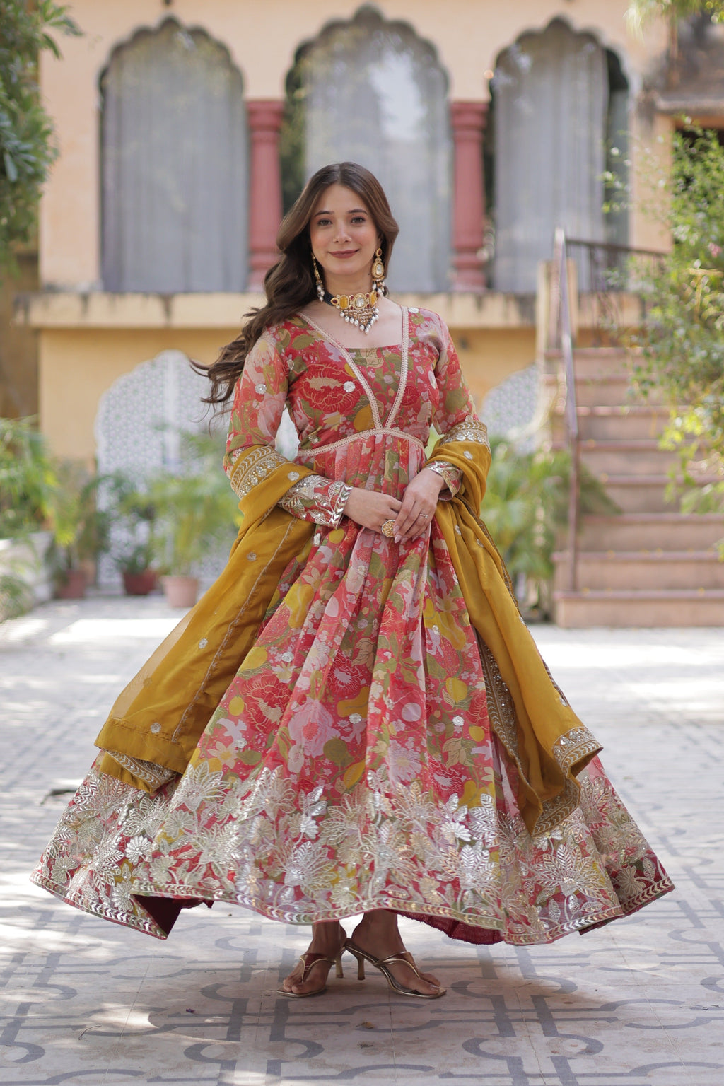 Woman wearing a red Russian silk Anarkali set with sequence embroidery and matching dupatta