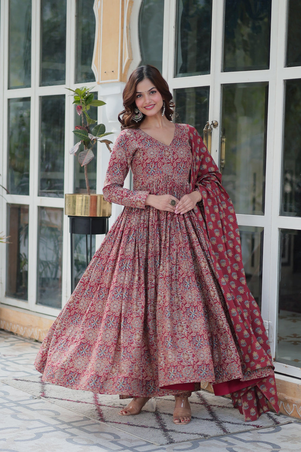 Women wearing a maroon A-line cotton kurta featuring a vibrant floral print