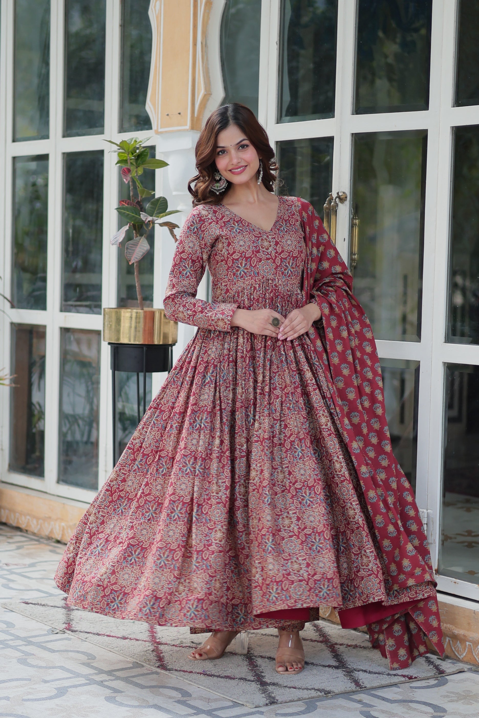 Women wearing a maroon A-line cotton kurta featuring a vibrant floral print
