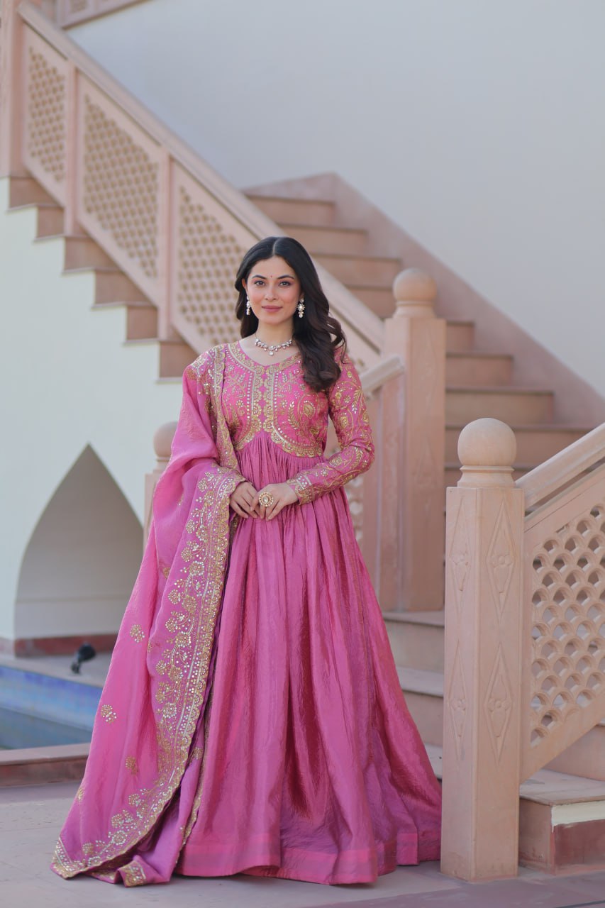 Woman wearing a pink gold crush Anarkali set with sequin embroidery and dupatta