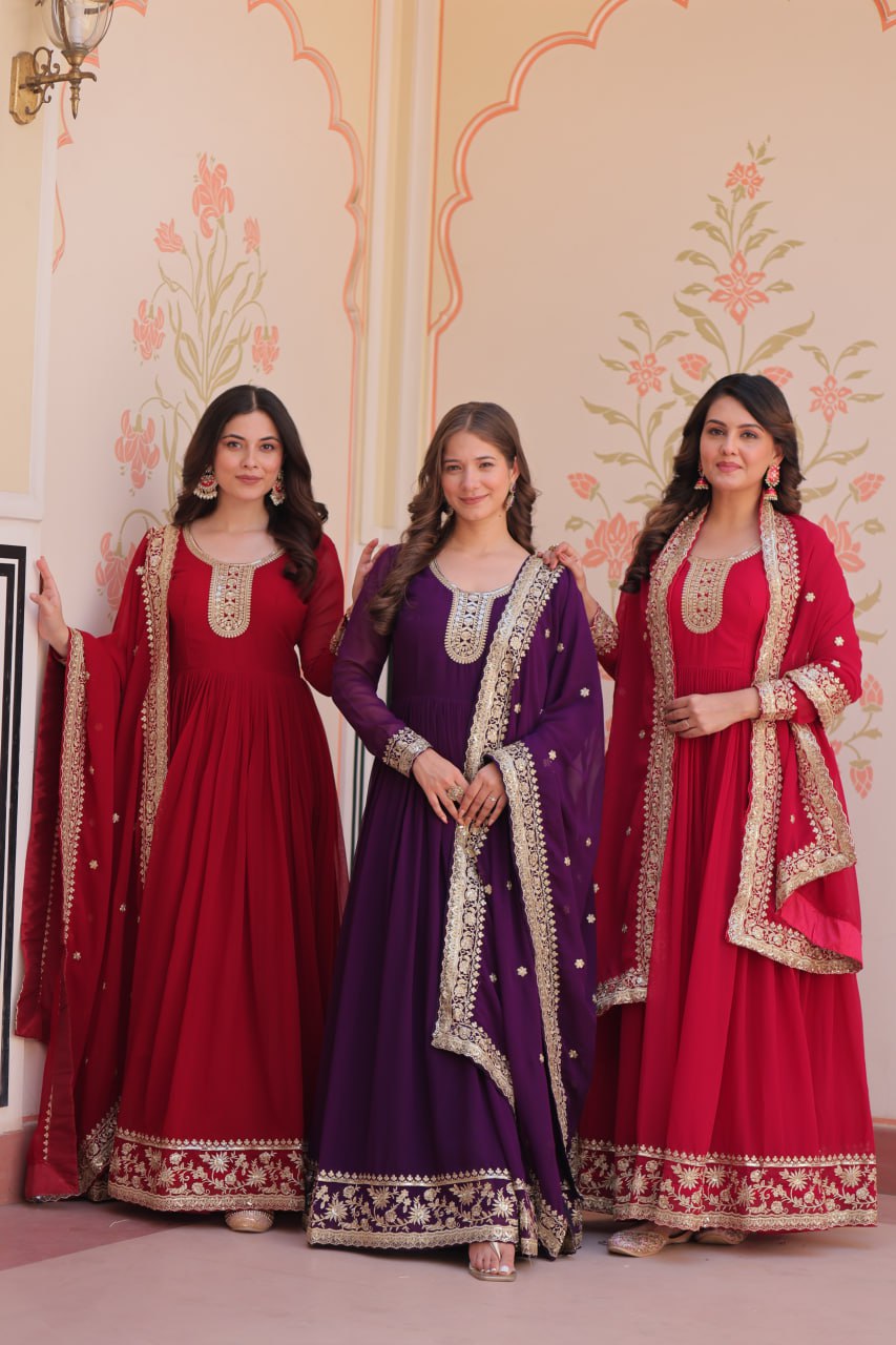 Woman wearing a maroon, purple, and rani Faux Blooming Anarkali set with sequin and zari embroidery.