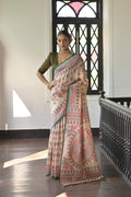Woman wearing a Mehendi colored Soft Tussar Silk saree with vibrant Madhubani print accents