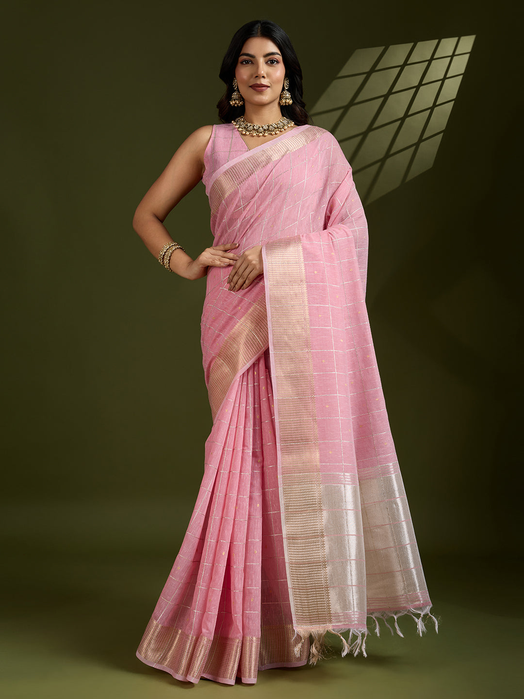 Pink tissue linen silk saree with delicate zari woven details and matching blouse piece.