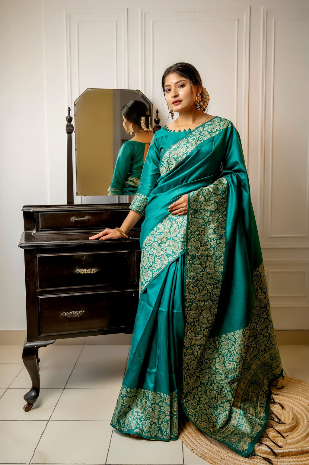 Rama colored handloom raw silk saree with detailed weaving patterns