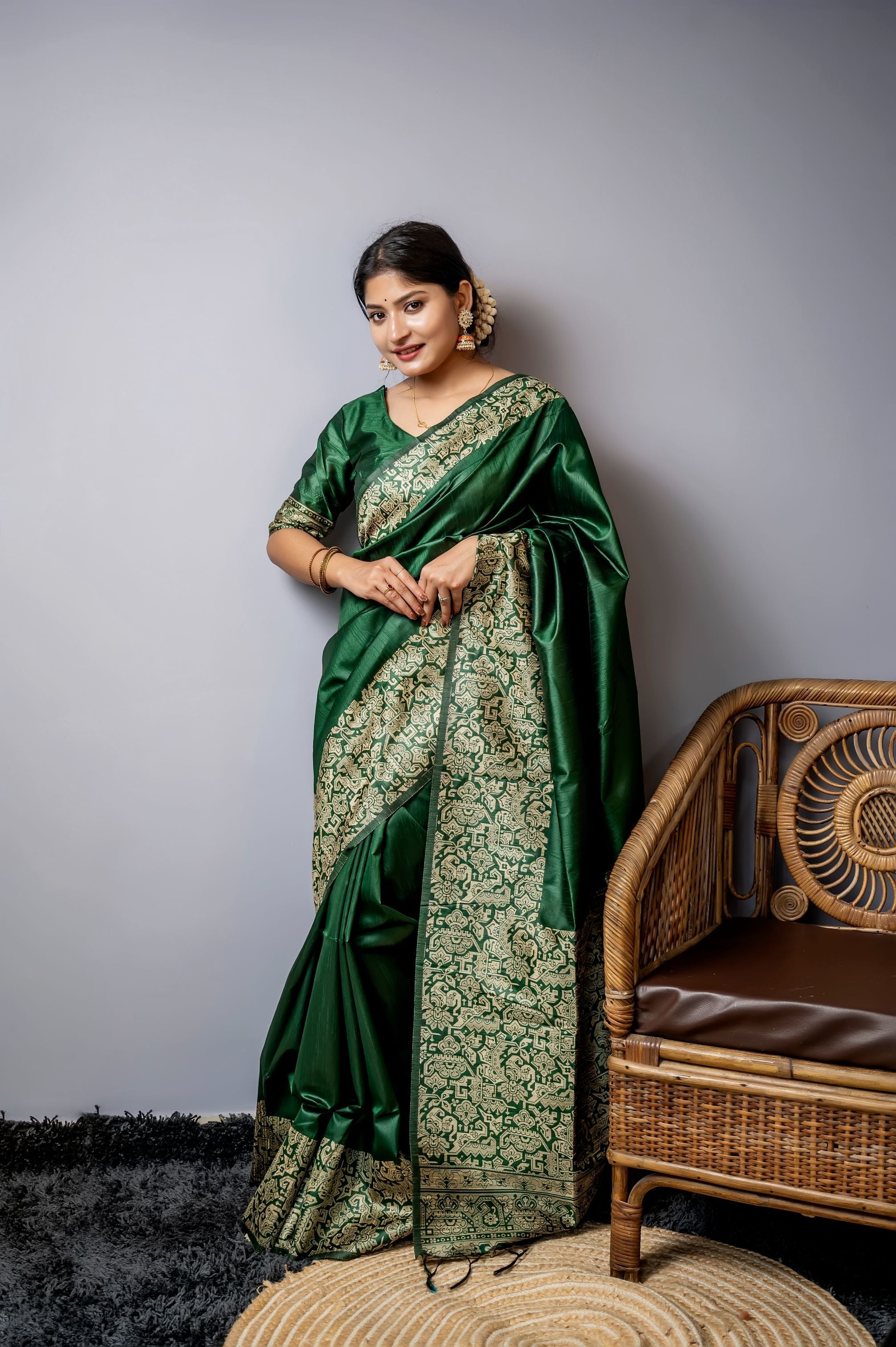 Bottle green handloom raw silk designer saree featuring exquisite weaving patterns.
