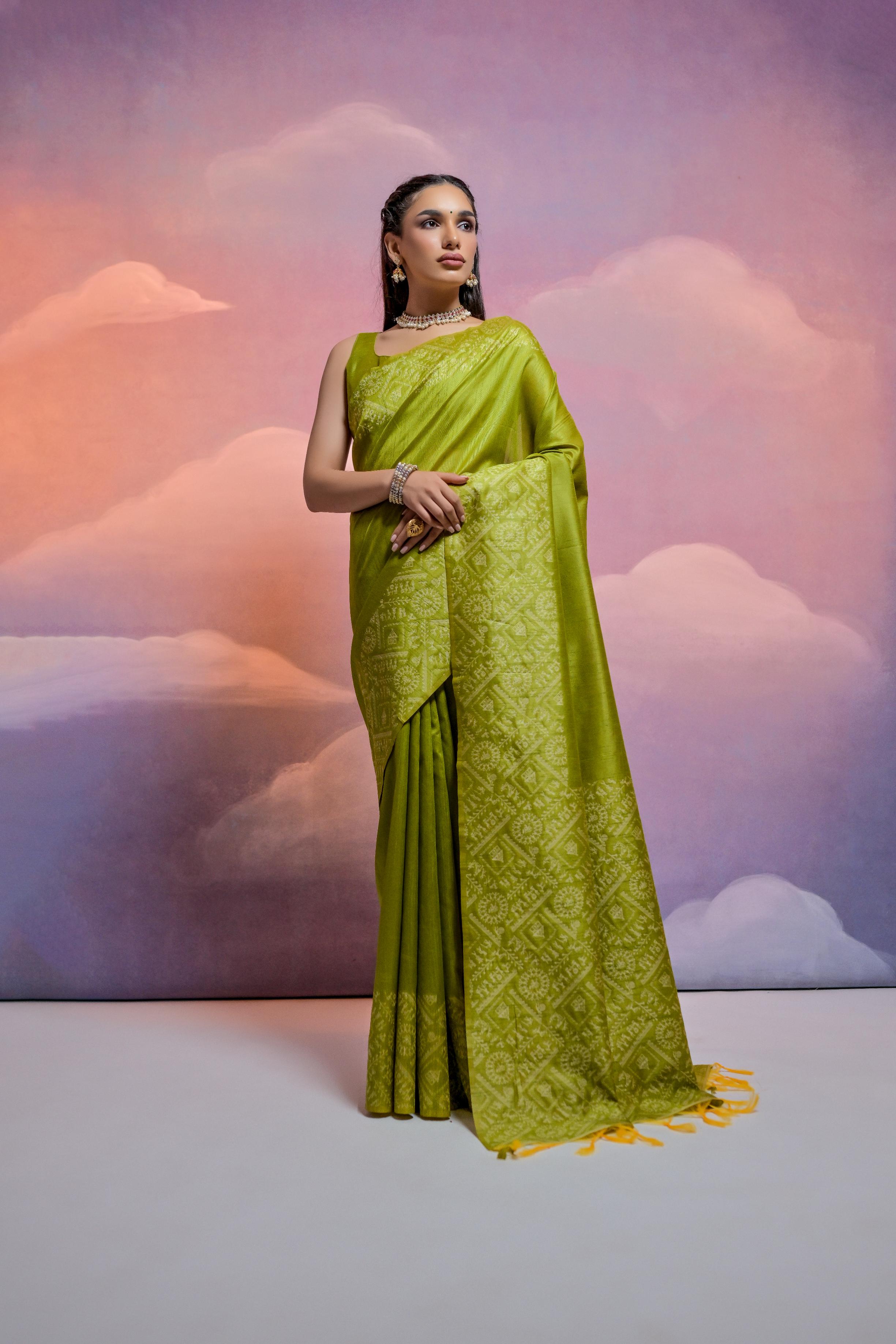Mehendi green handloom raw silk saree with geometric weaving patterns and matching blouse piece.