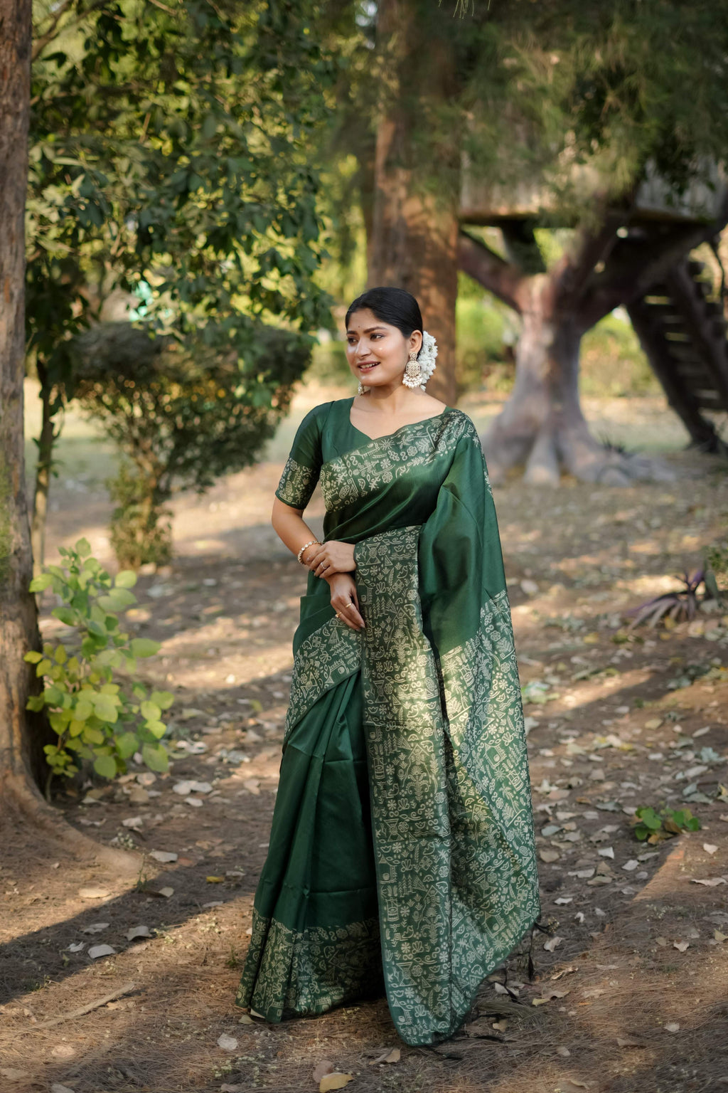 Bottle green handloom raw silk saree with detailed weaving on the pallu.