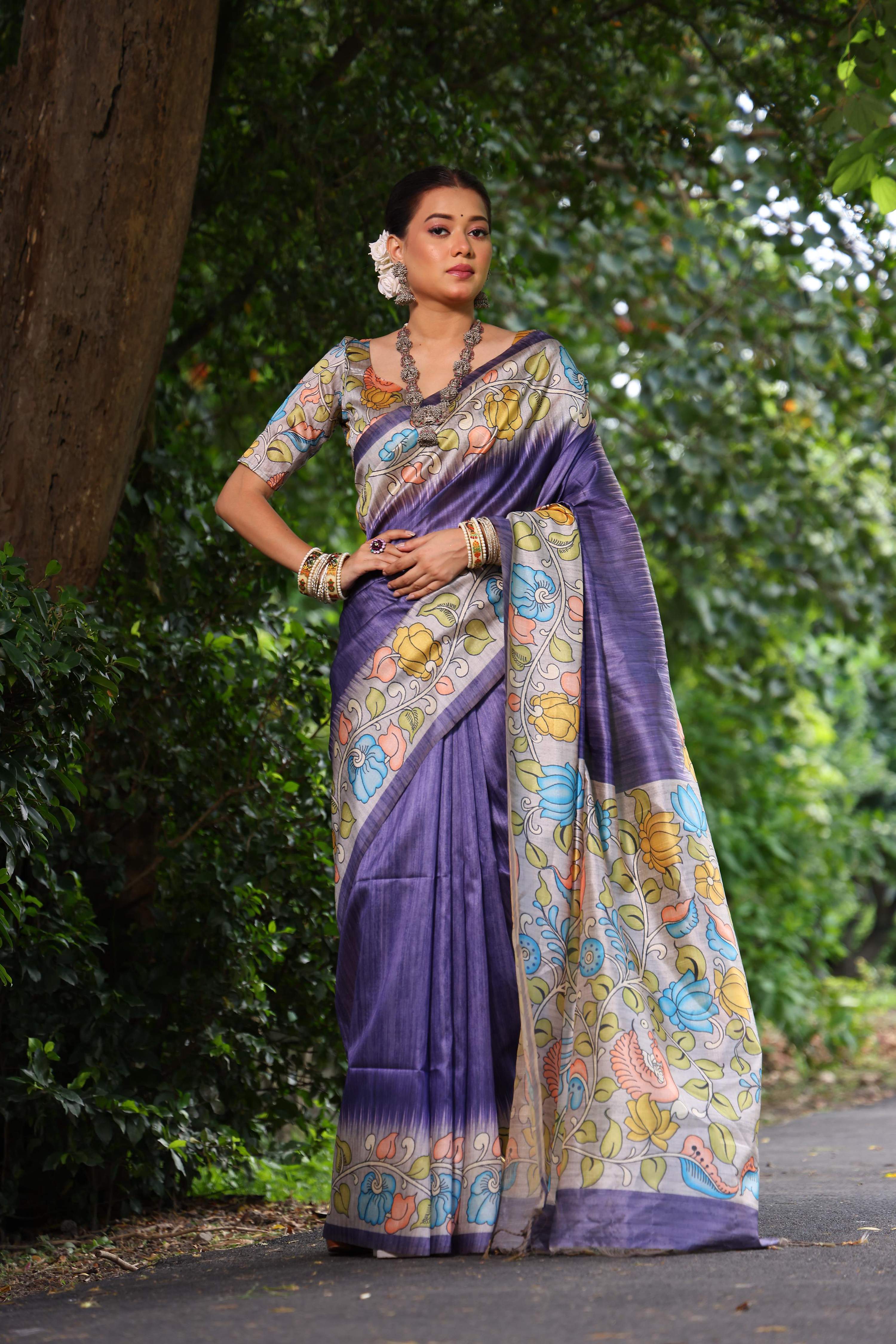 Purple soft Tussar silk saree with traditional Kalamkari prints and matching blouse fabric.