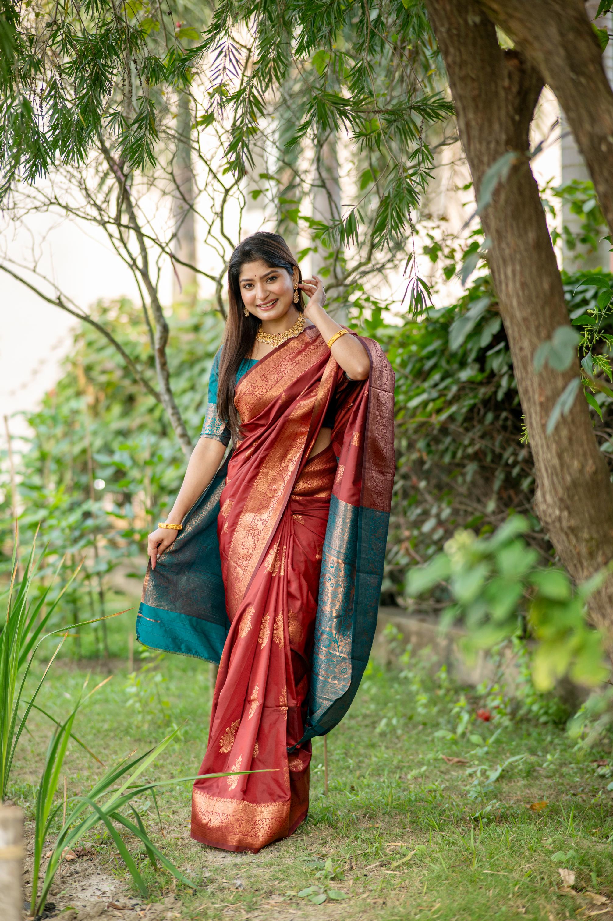 Maroon Banarasi silk saree featuring traditional zari woven patterns