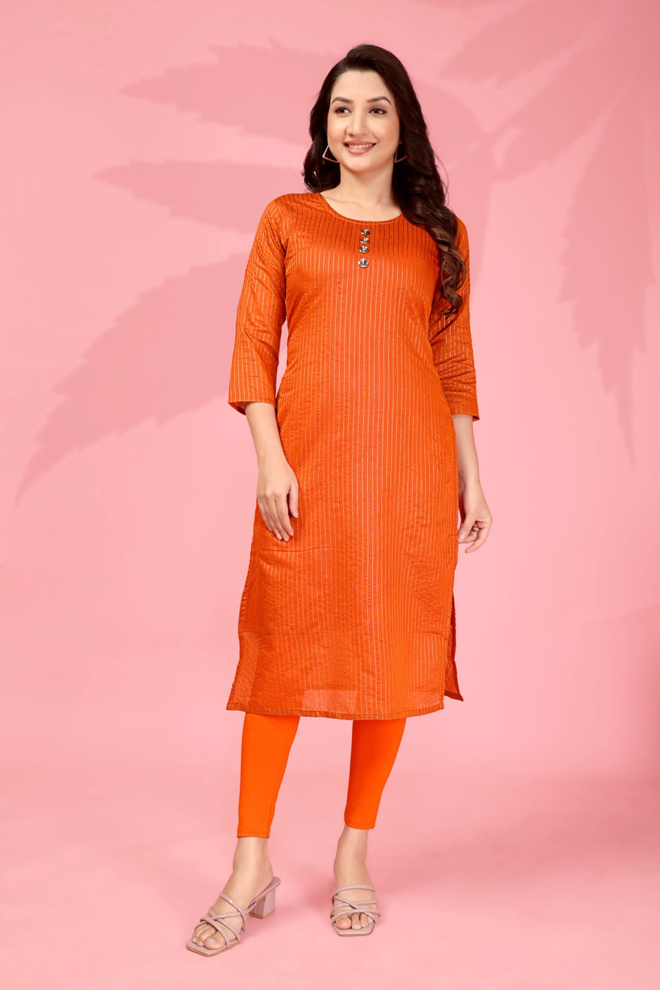Women wearing a vibrant orange Kanchi cotton straight kurti with zari woven details and side slits.