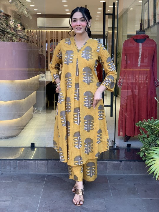 Woman wearing a yellow rayon slub straight kurta set with printed dupatta