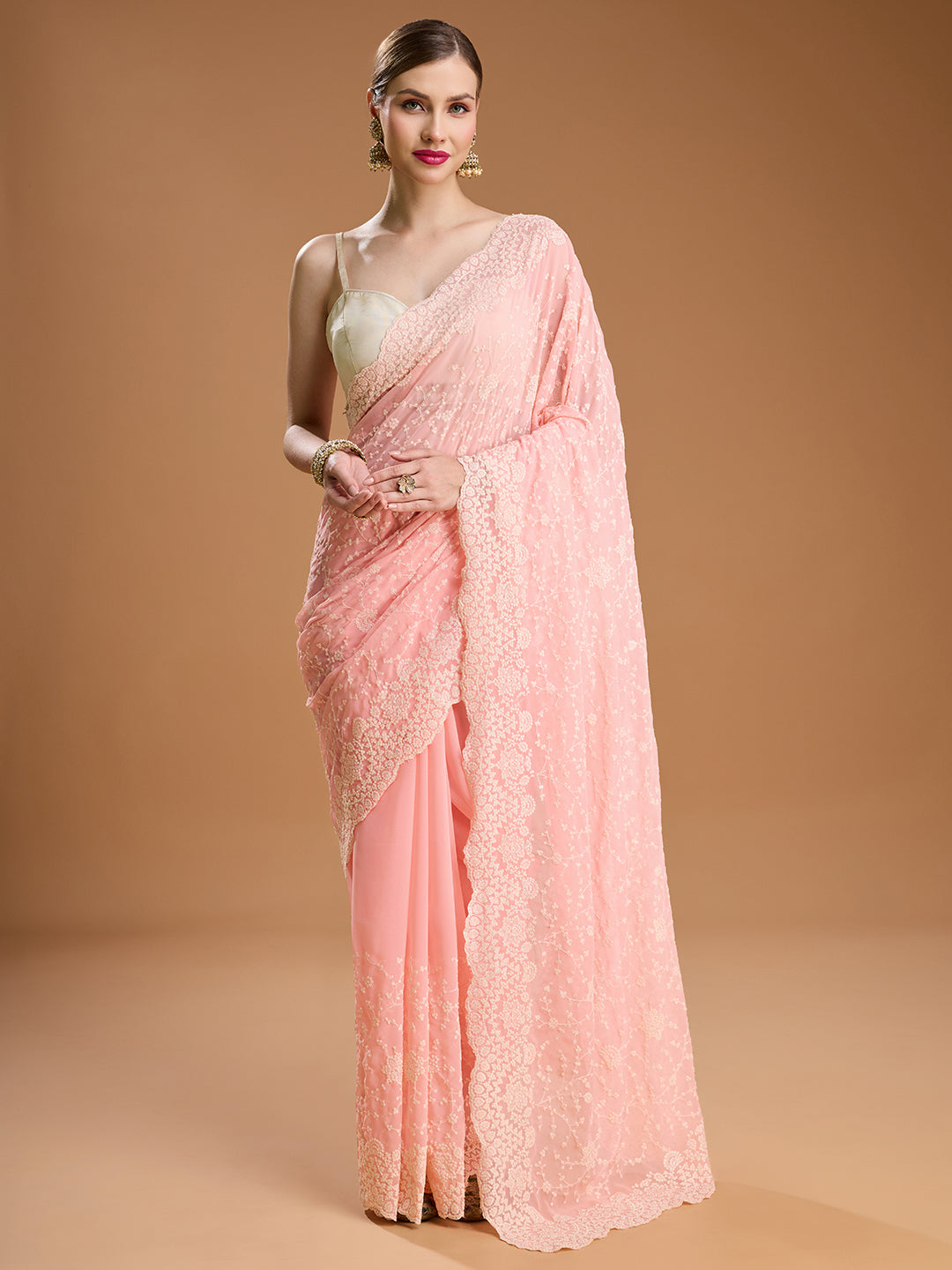 Elegant baby pink chiffon saree with intricate embroidery for formal Indian occasions