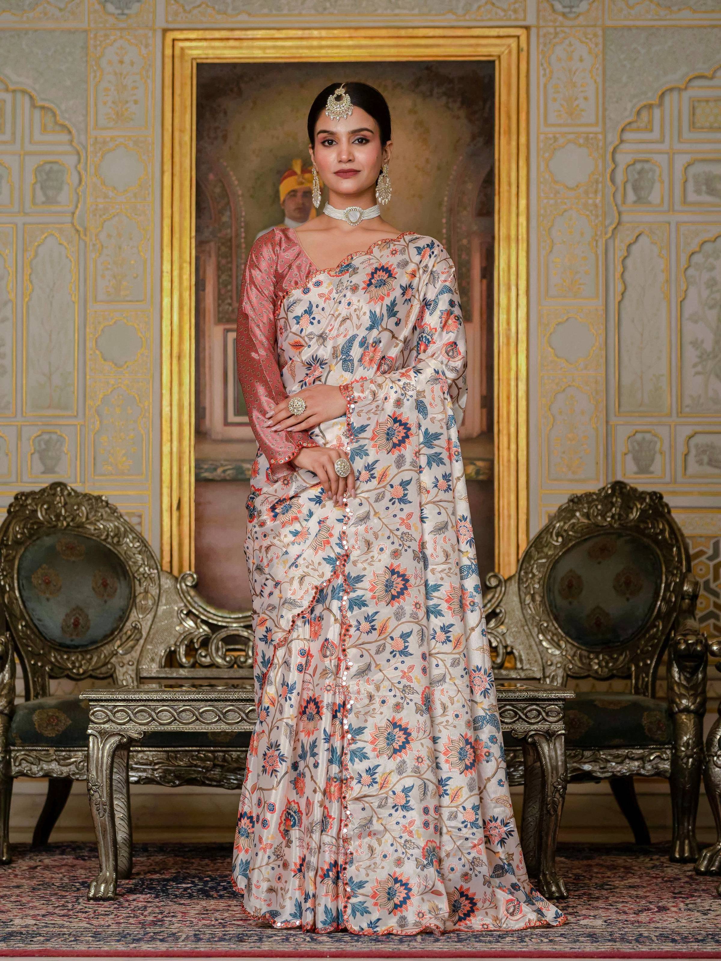 A woman wearing a multicolor Chinon silk saree with digital floral prints and intricate mirror work detail.