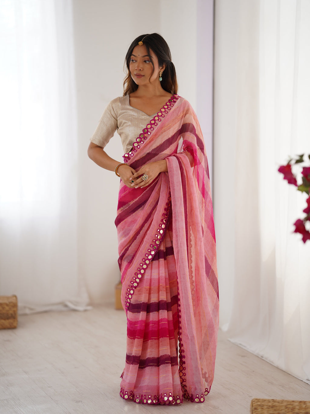 Pink Chinon saree with Leriya print, Zari details, and decorative paper mirror border.