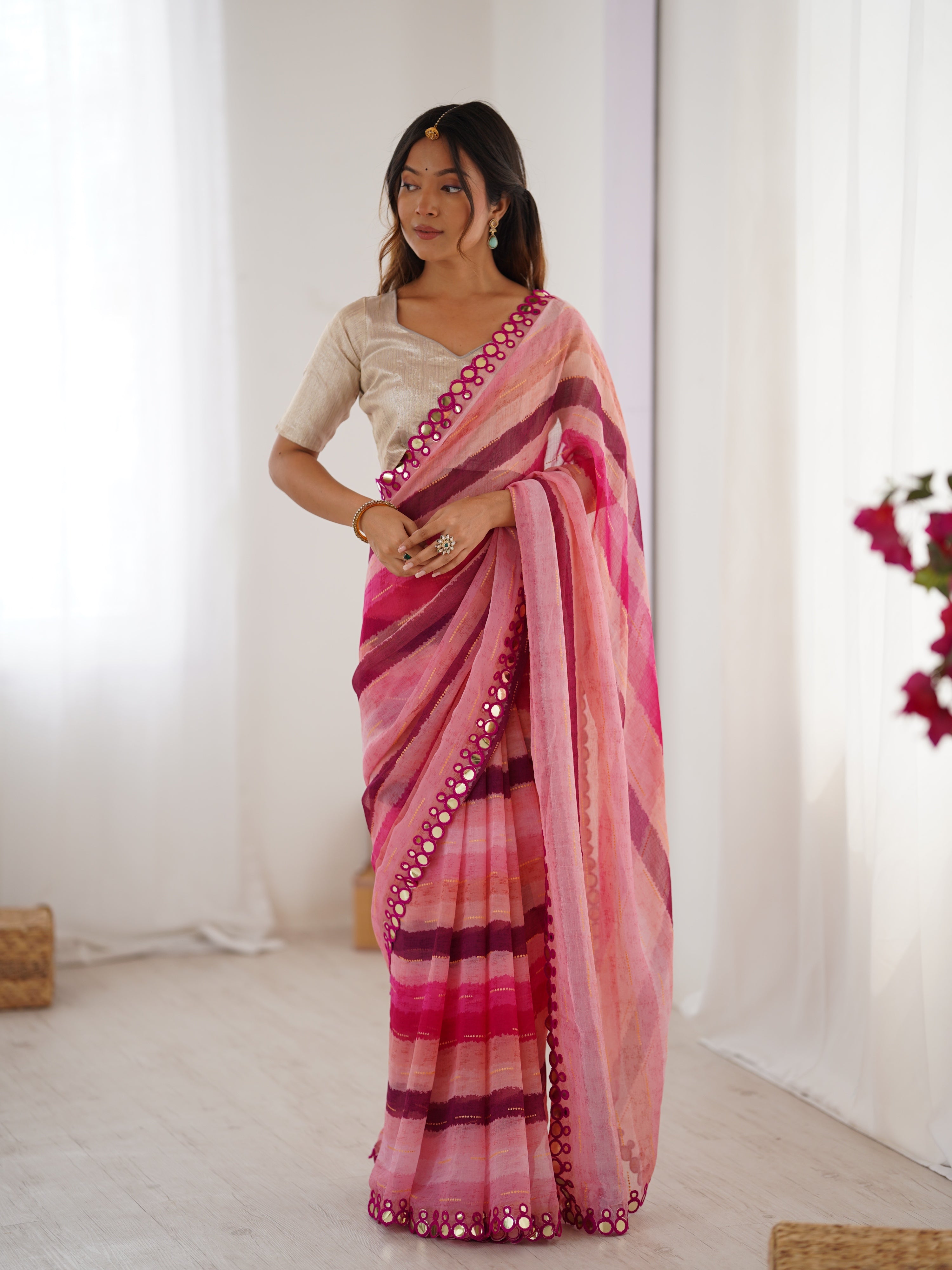 Pink Chinon saree with Leriya print, Zari details, and decorative paper mirror border.