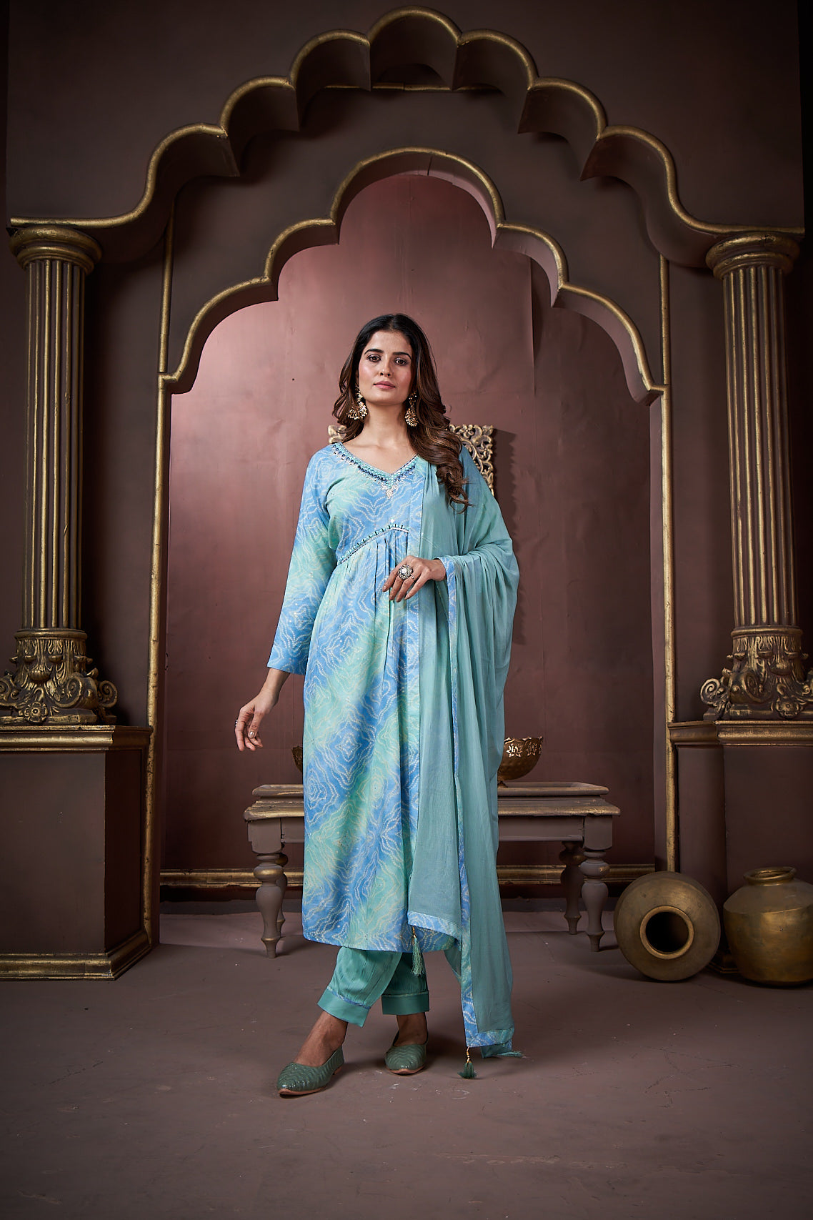 Woman wearing a sky blue floral print rayon kurta set with handwork and a matching dupatta