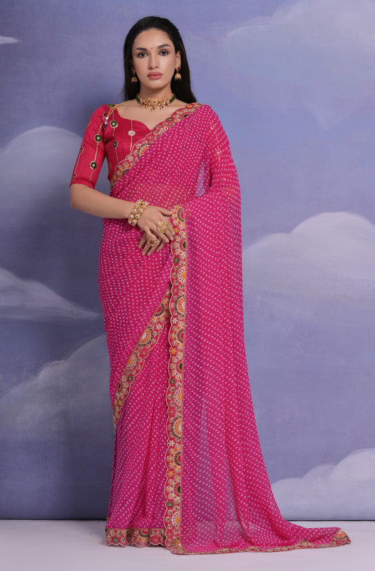 Rani pink georgette saree featuring intricate multi-thread and sequence coding embroidery.