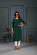 A stylish green cotton kurta for women featuring delicate handwork and side pockets.