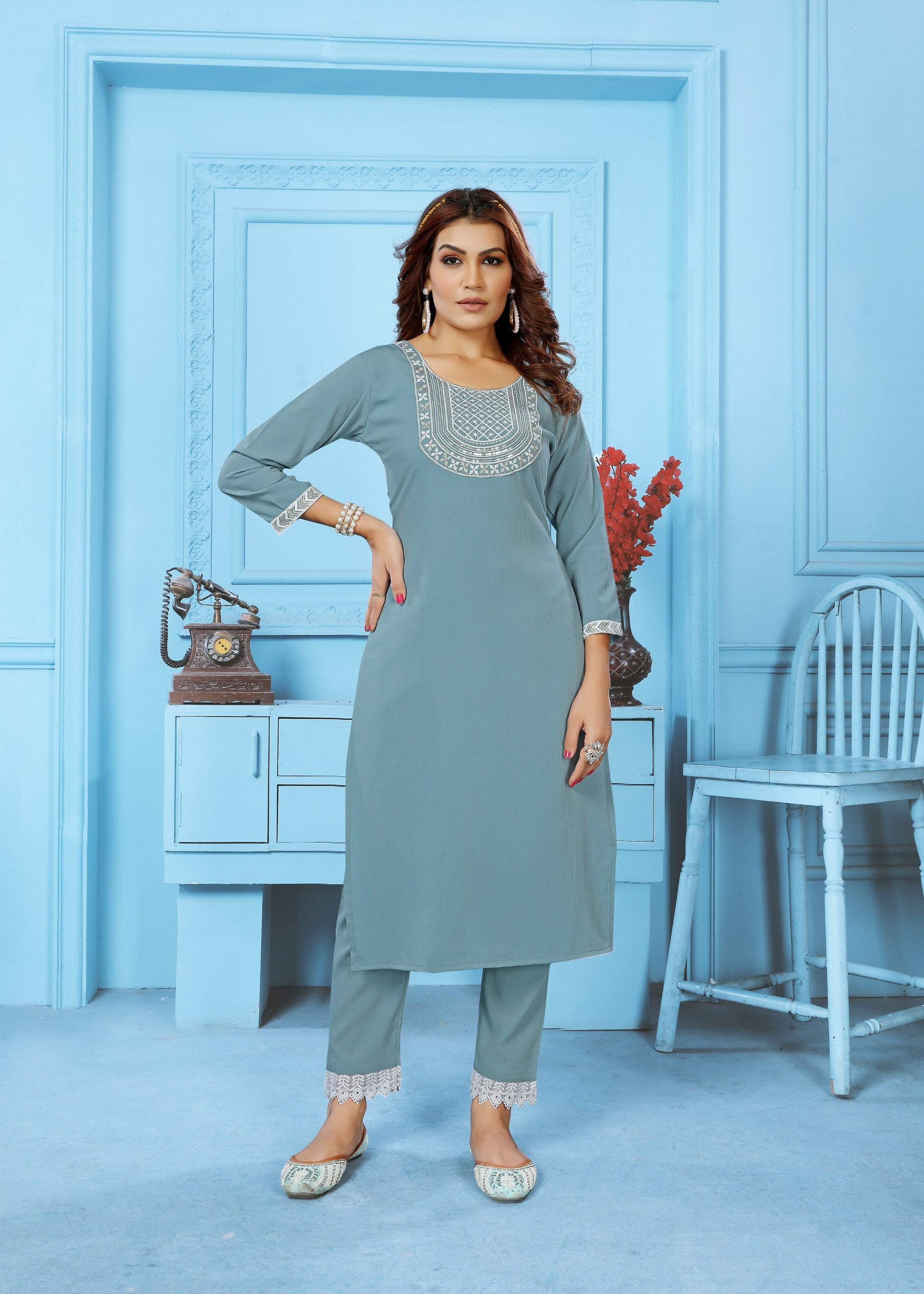A grey Rinkal cotton embroidered kurta set paired with matching bottoms.