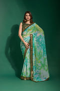 Sea green chiffon saree with sequence embroidery, complete with a matching blouse piece.