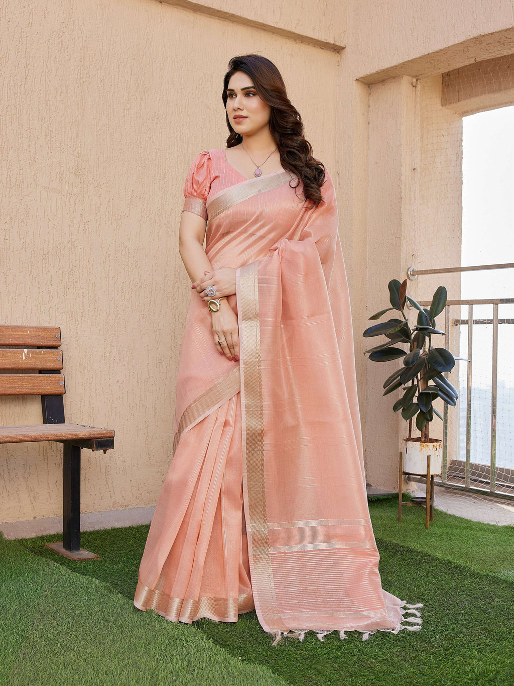 Elegant peach soft tissue linen silk saree with Zari woven border