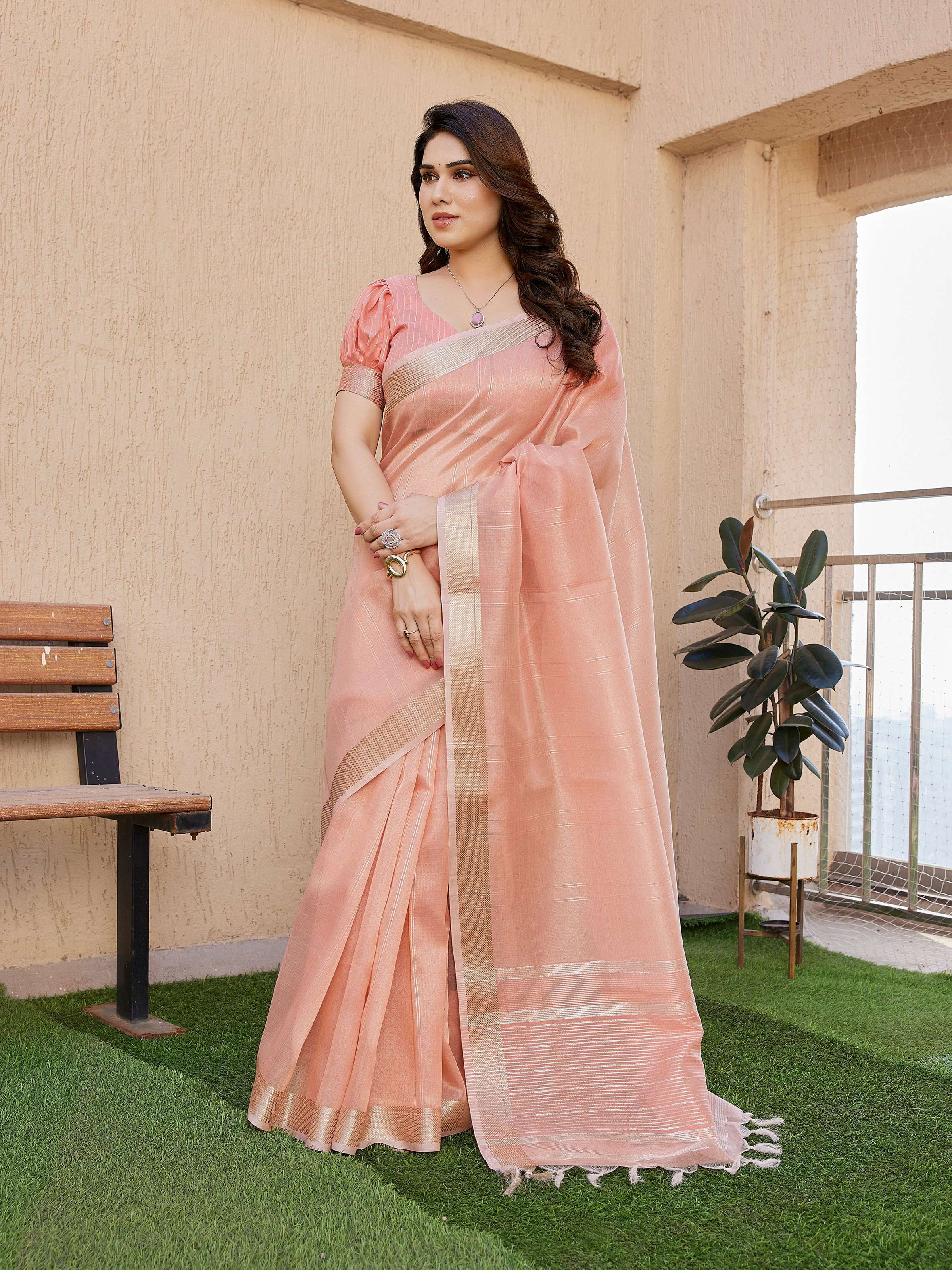Elegant peach soft tissue linen silk saree with Zari woven border