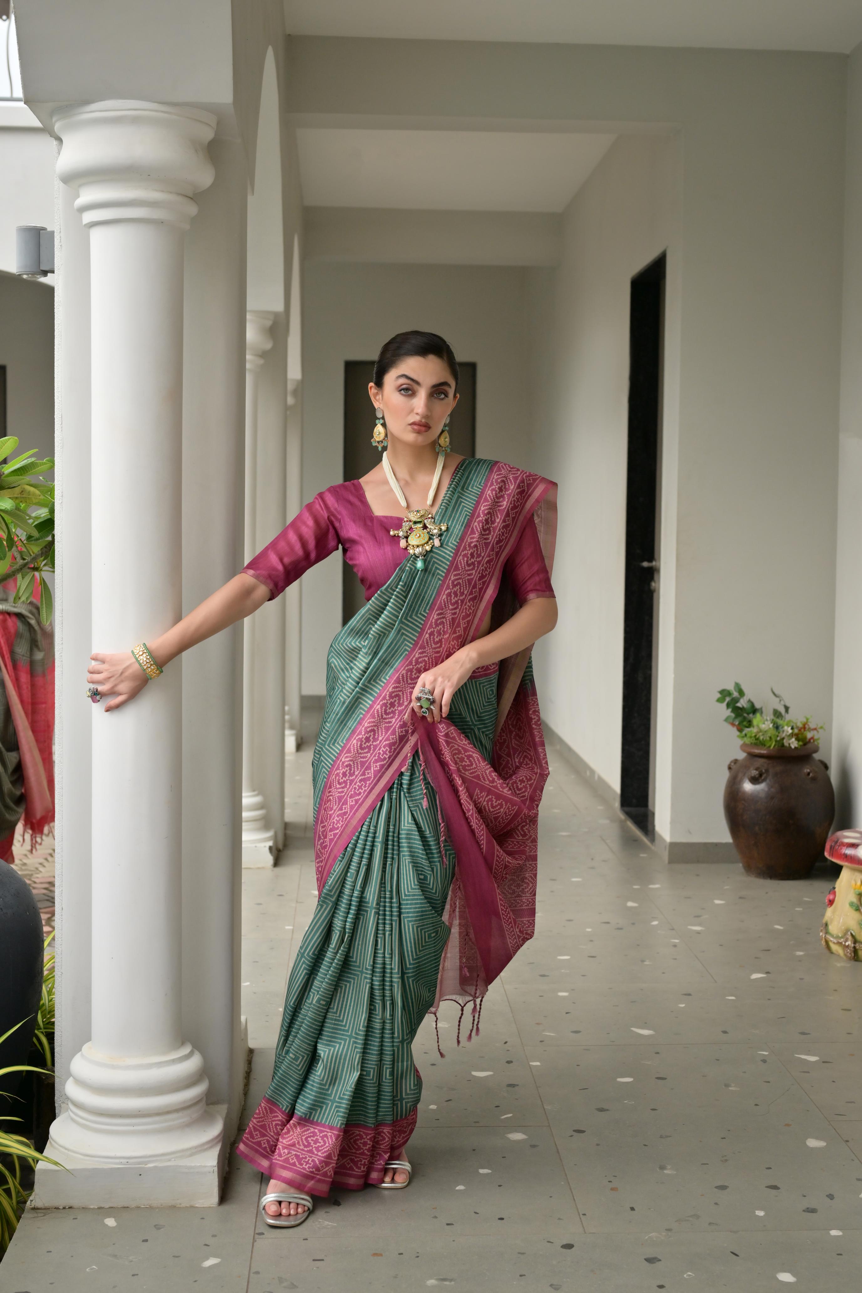 Bottle green soft tussar silk saree with traditional ikkat prints and matching blouse.