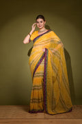Yellow georgette saree with gold foil print and sequence embroidery