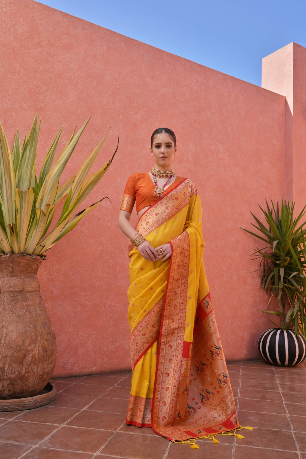 Bright yellow Paithani style silk saree with intricate gold zari woven border