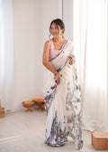 Stunning white Chinon designer saree featuring colorful digital prints and a mirror lace border.