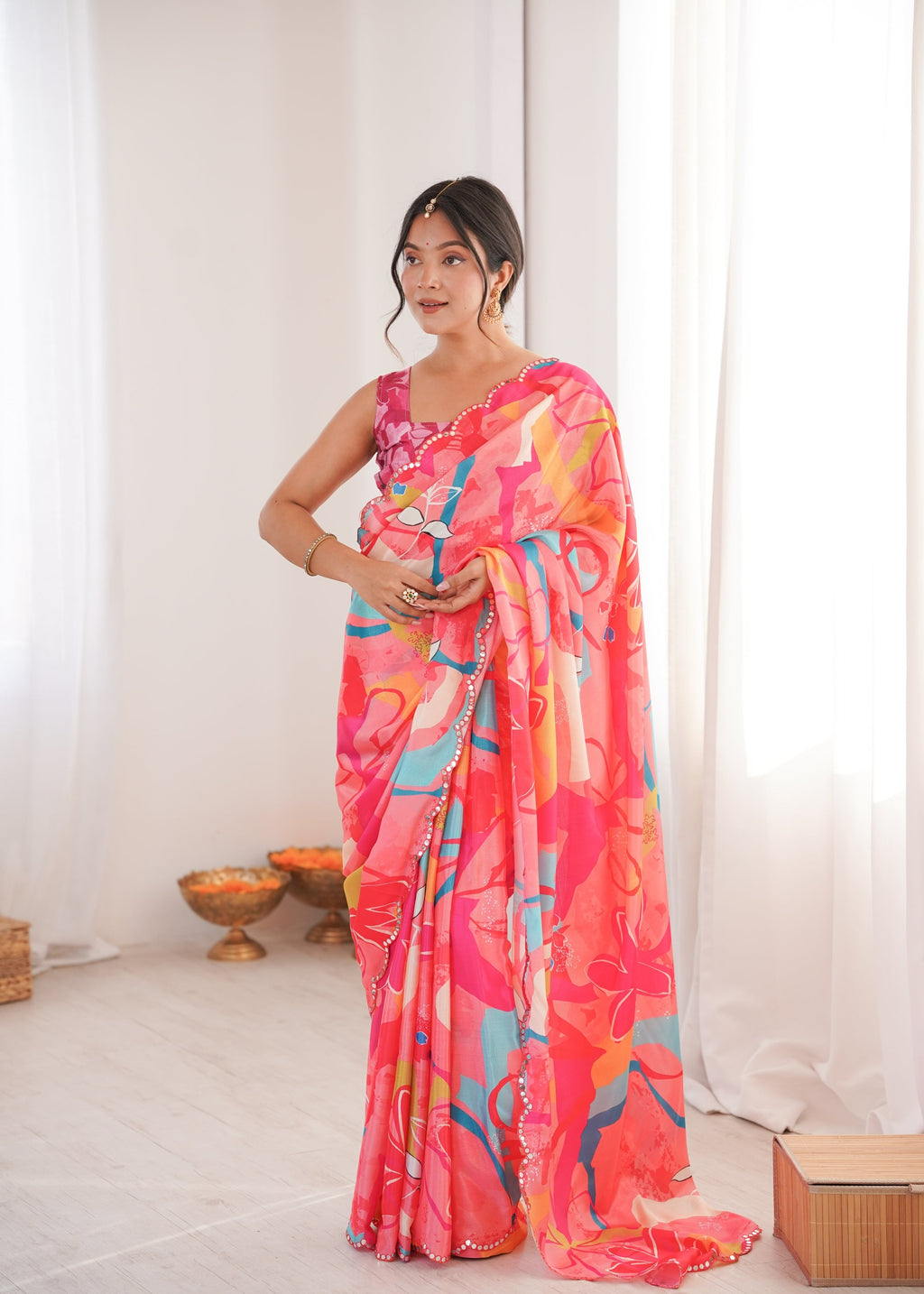 Women wearing a vibrant multicolor Chinon digital printed designer saree with detailed mirror lace border.