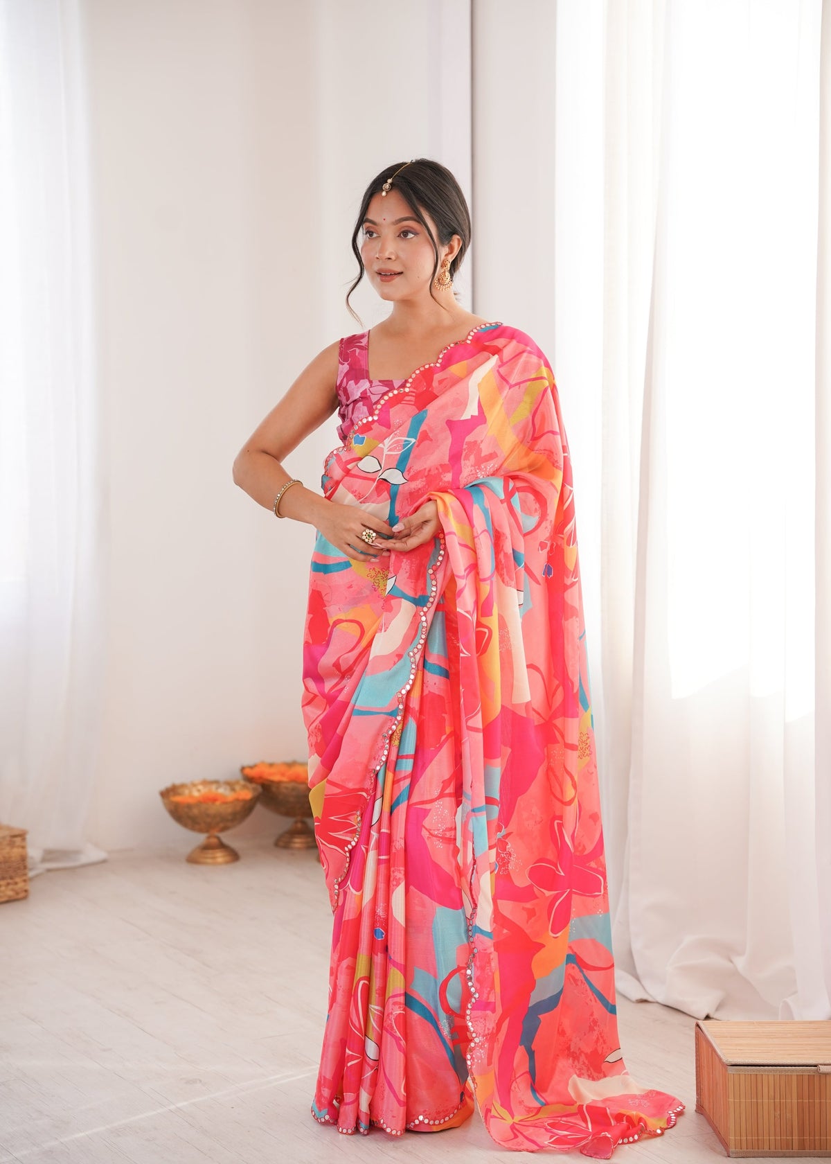 Women wearing a vibrant multicolor Chinon digital printed designer saree with detailed mirror lace border.