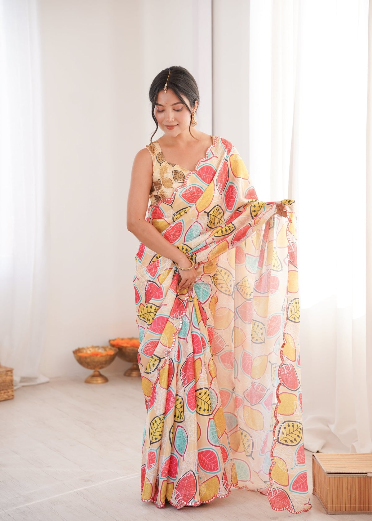 Women wearing a vibrant multicolor Chinon digital printed designer saree with detailed mirror lace border.