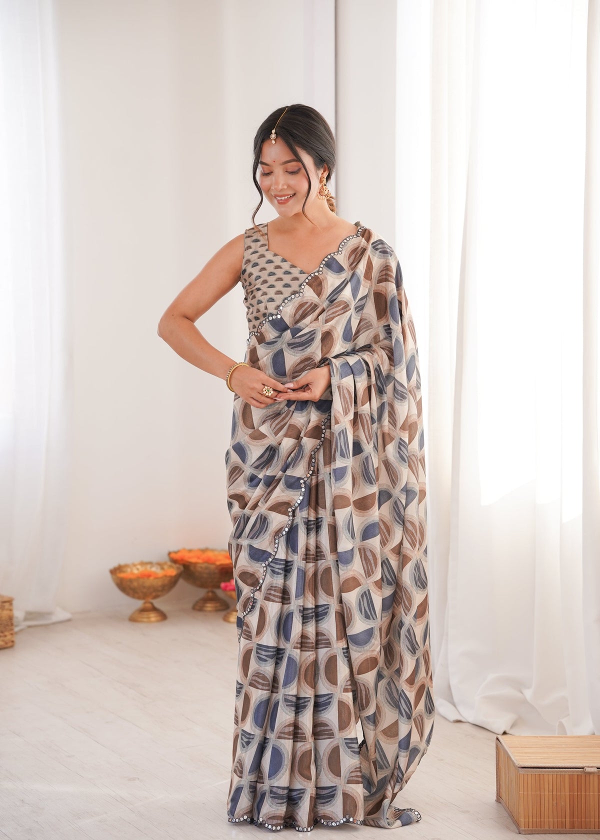 Women wearing a vibrant multicolor Chinon digital printed designer saree with detailed mirror lace border.