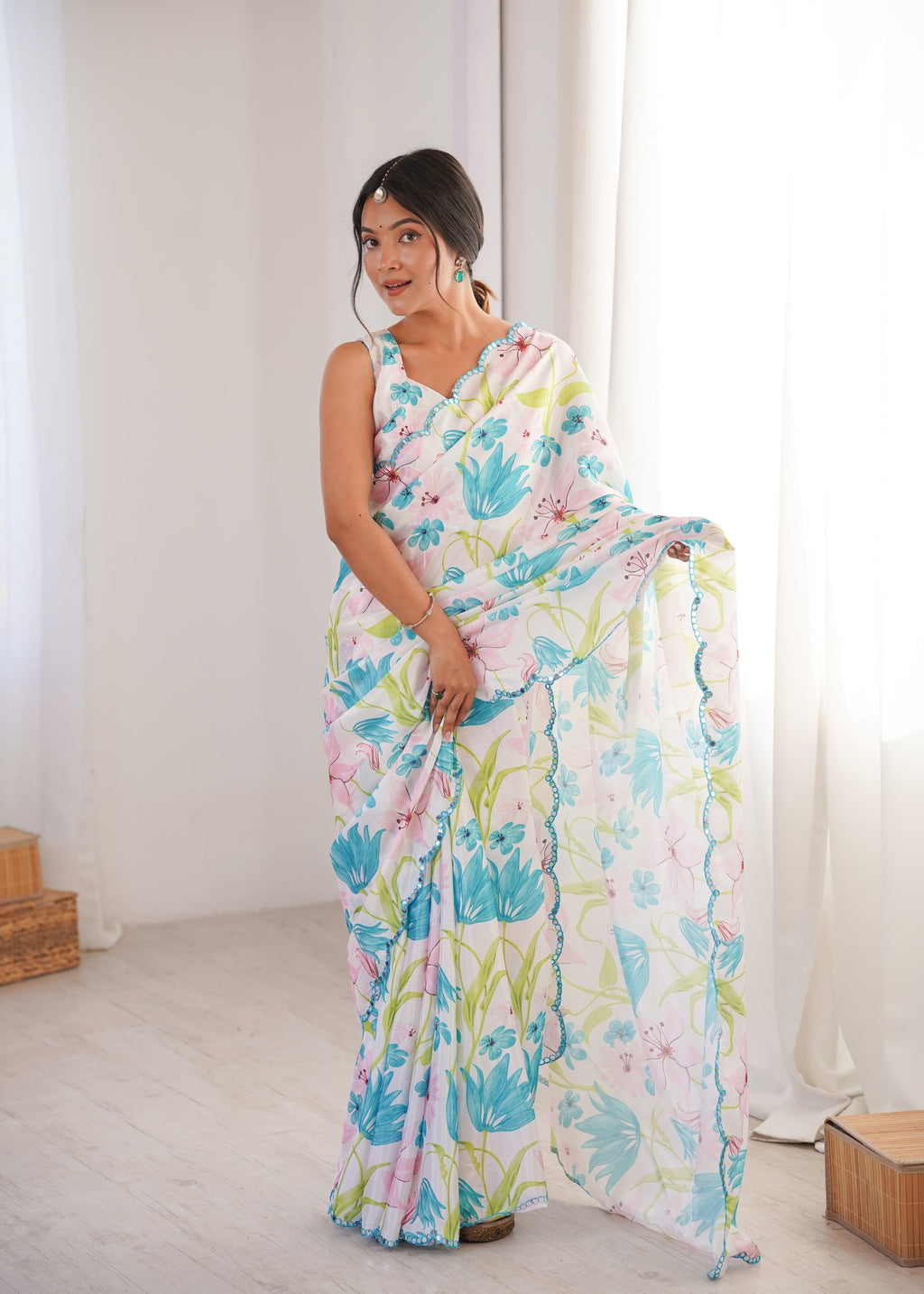Women wearing a vibrant multicolor Chinon digital printed designer saree with detailed mirror lace border.