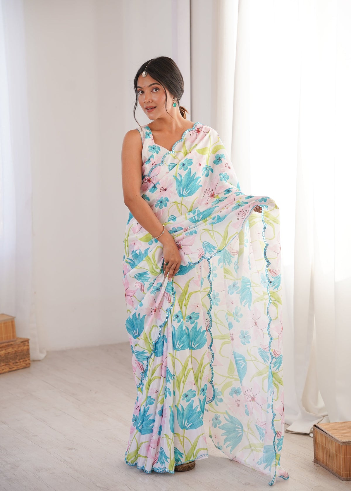 Women wearing a vibrant multicolor Chinon digital printed designer saree with detailed mirror lace border.