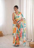 Women wearing a vibrant multicolor Chinon digital printed designer saree with detailed mirror lace border.