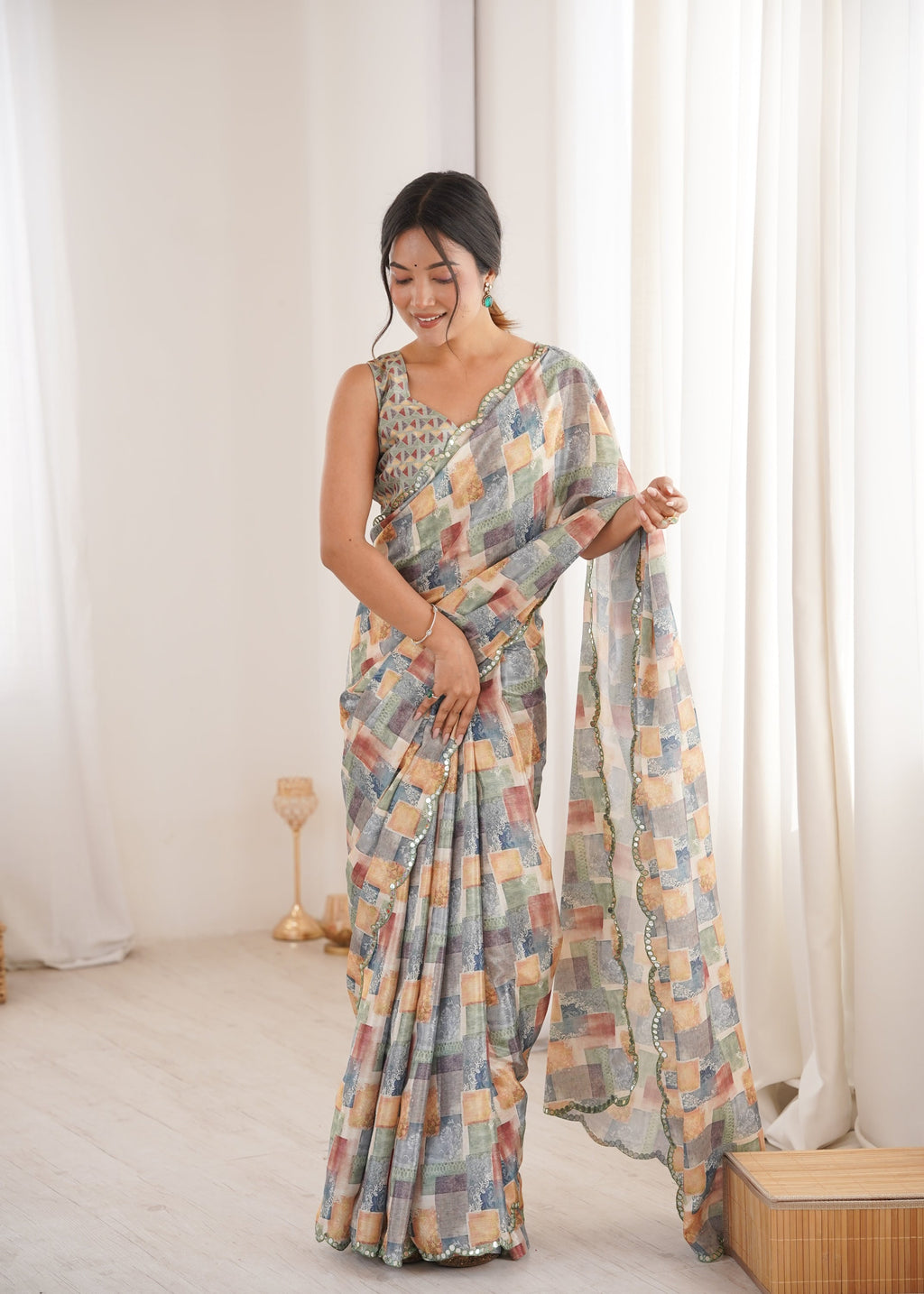 Women wearing a vibrant multicolor Chinon digital printed designer saree with detailed mirror lace border.