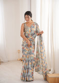 Women wearing a vibrant multicolor Chinon digital printed designer saree with detailed mirror lace border.