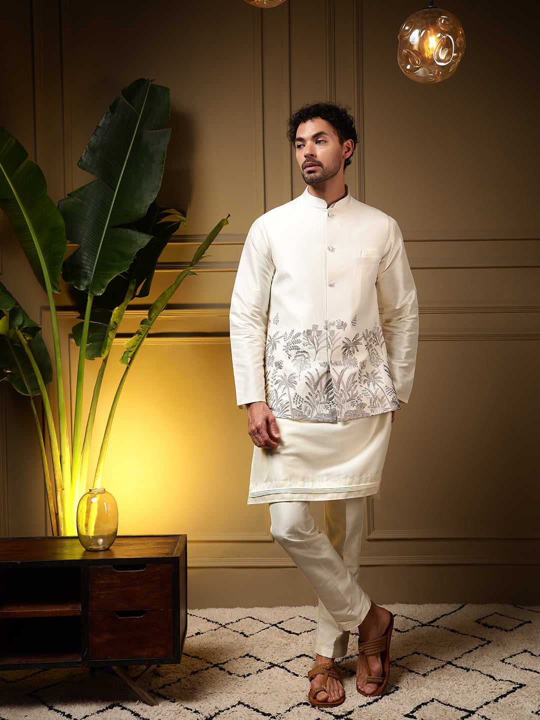 Men wearing a grey slub silk kurta set with a matching embroidered koti waistcoat