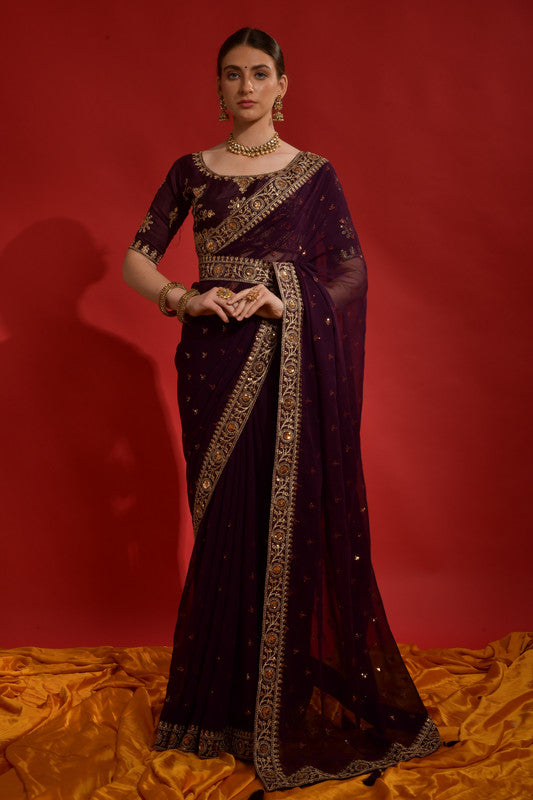 Wine-colored georgette saree with fine sequence coding embroidery.