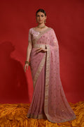 Close up of peach georgette saree with sequence coding embroidery details.