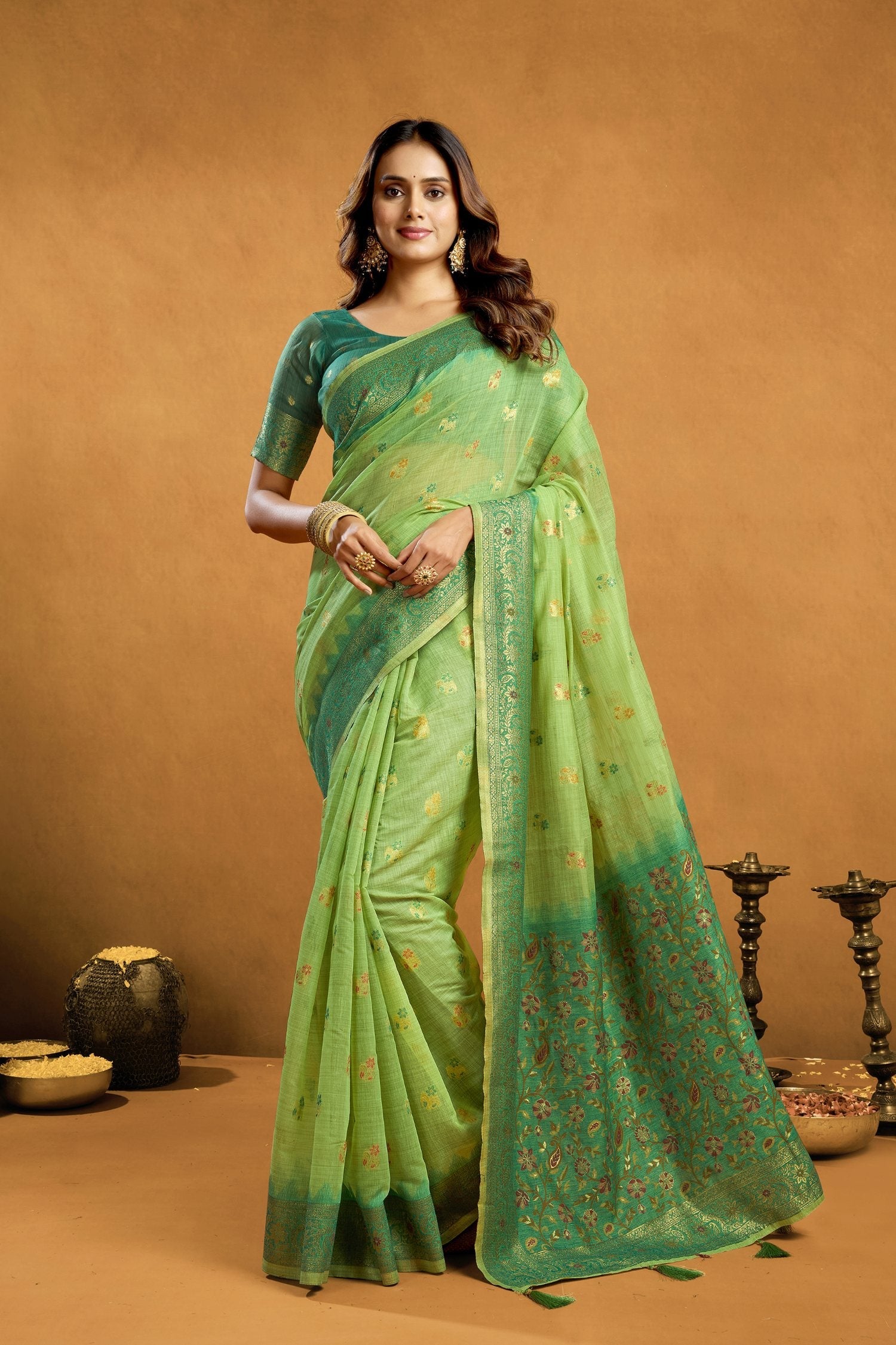 Elegant green premium spun cotton saree with gold zari weaving and jhalar border