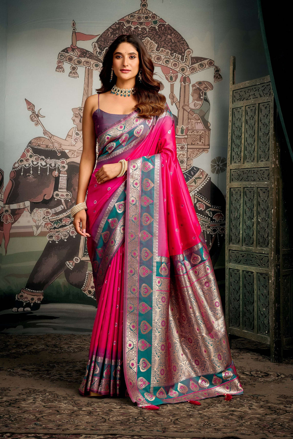 Pink soft silk saree with Zari woven detail and matching blouse piece.
